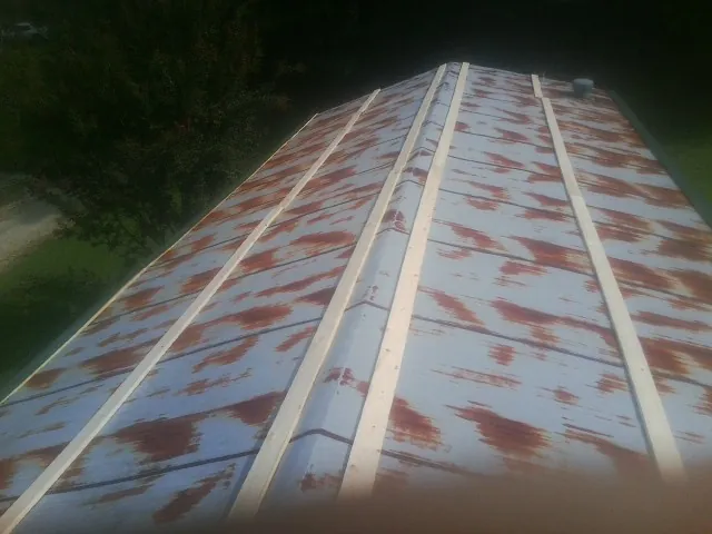 Rusted metal roof panels with new wood purlins before replacement — Storm Damage Roof Repair in Pueblo by Roofing Brothers